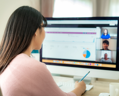  woman talking to her colleagues using cloud-based communication solutions; hybrid work communication